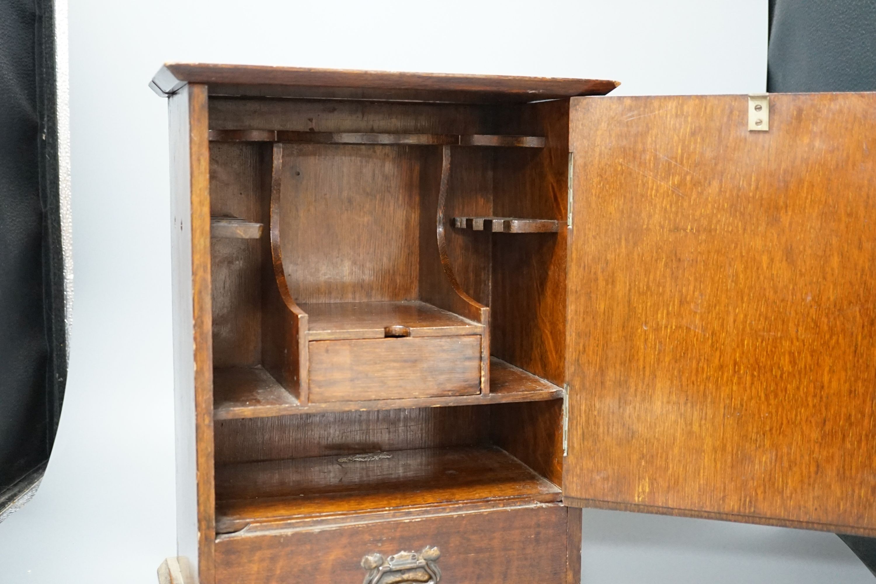 A late Victorian smokers cabinet with embossed metal panel to door and fitted interior 40cm